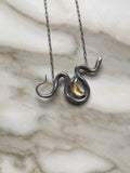 Sterling Silver Snake Necklace with Golden Crescent Moon on marbled background