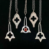 a collection of gothic architecture necklaces in sterling silver with garnets