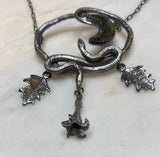 Double Serpent Snake Necklace with labradorite Crescent Moon close up on datura flowers