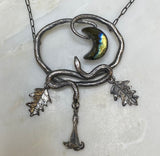 Double Serpent Snake Necklace with labradorite Crescent Moon with datura shown on white marble