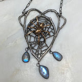 Naturalistic Sterling Silver and Bronze Wolf Spider Necklace with Moonstones, luxury gothic jewelry Marble Background view