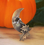 Datura Waning Crescent Moon Necklace in Sterling Silver pumpkin background