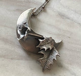 Datura Waning Crescent Moon Necklace in Sterling Silver marble background
